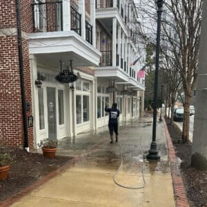 Pressure Washing Men Team performing soft washing service to house windows in suwanee georgia